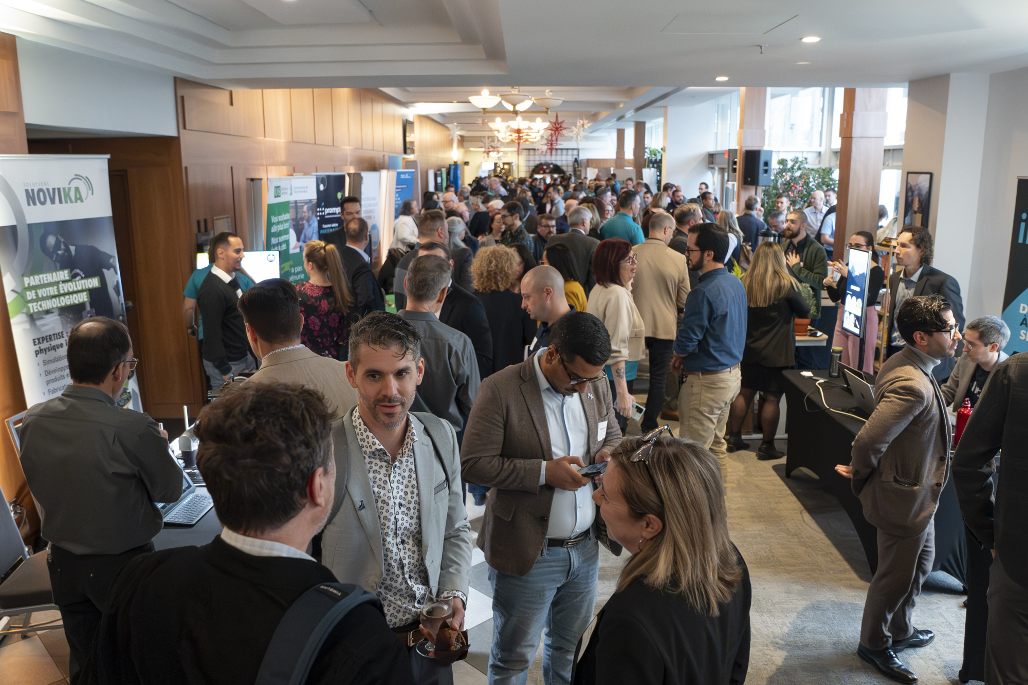 Attendees networking and interacting at a busy exhibition area at RDV Innov 